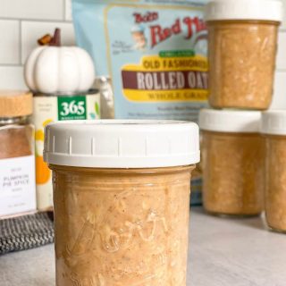 Pumpkin Spice Overnight Oats in a mason jar in front of ingredients