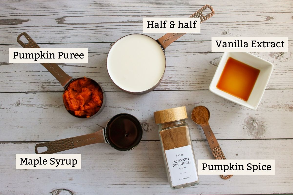 Ingredients for pumpkin spice creamer on a white wooden surface
