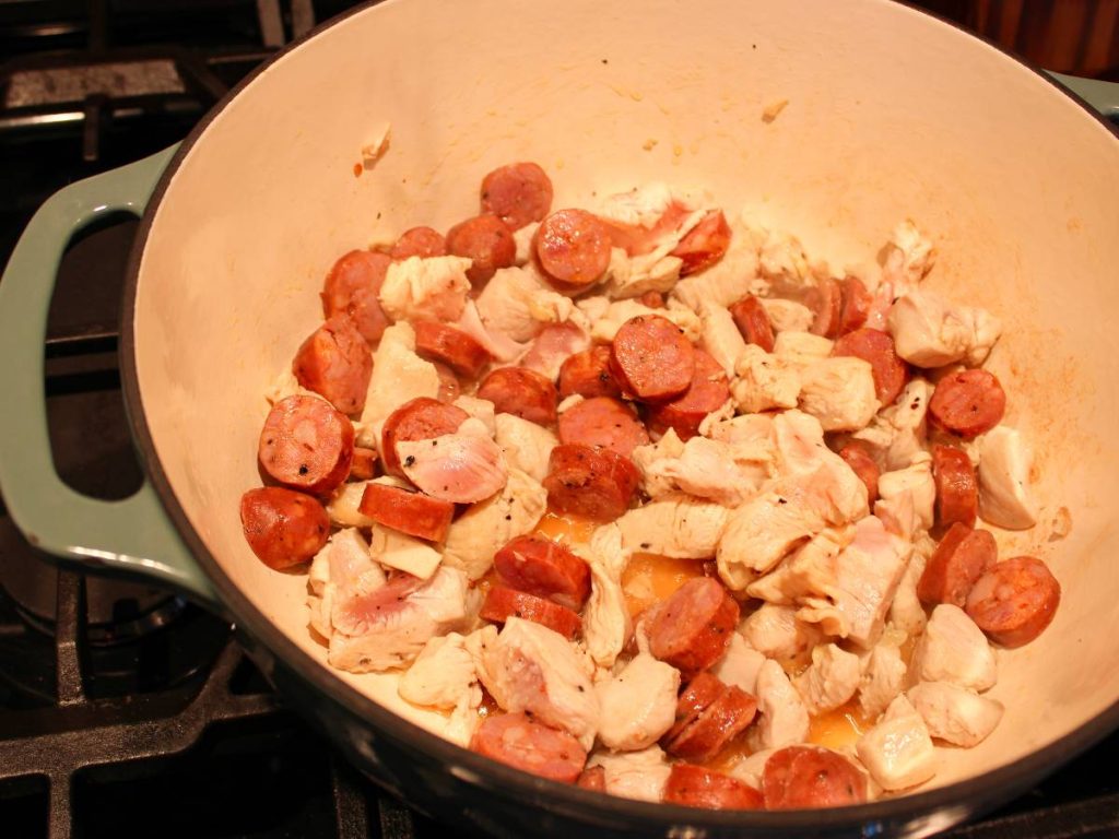 Chicken and sausage browning in dutch oven