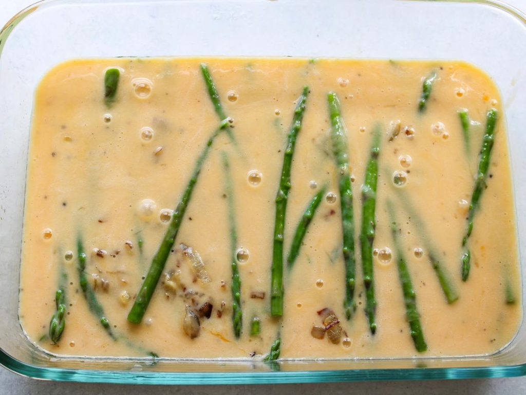 Uncooked Frittata with asparagus, onions and egg mixture