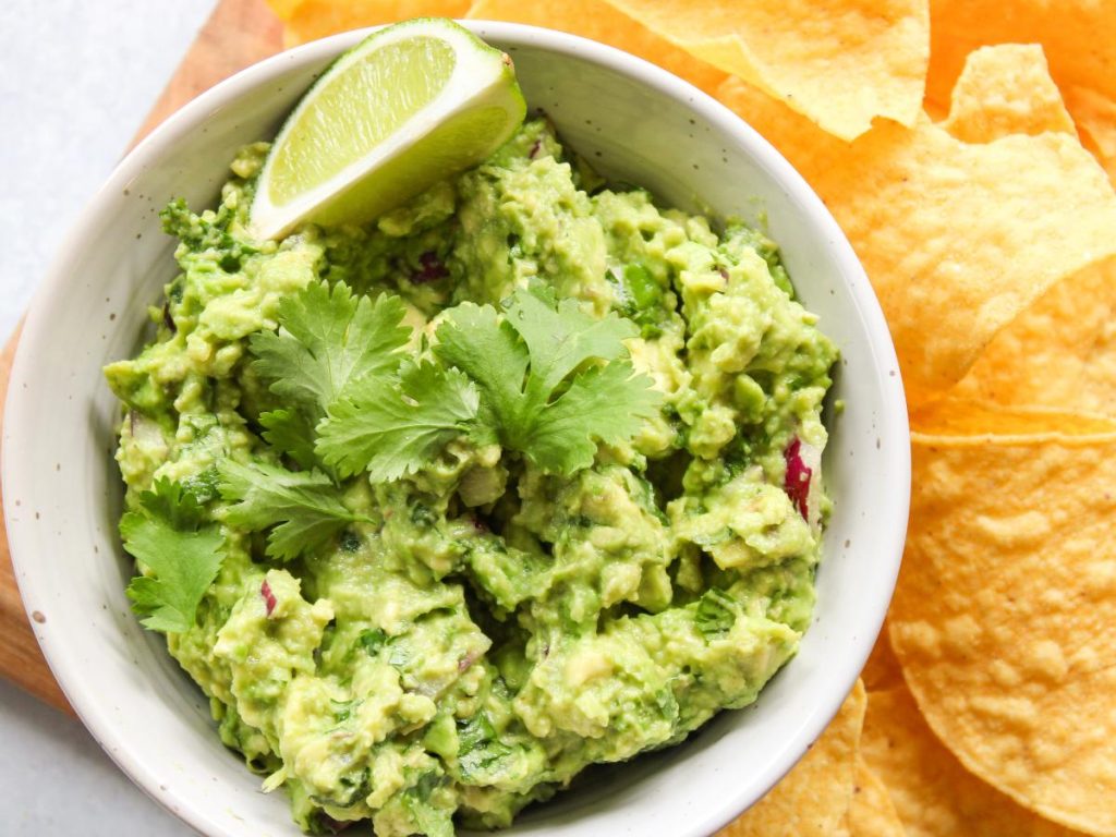 bowl of guacamole with a lime