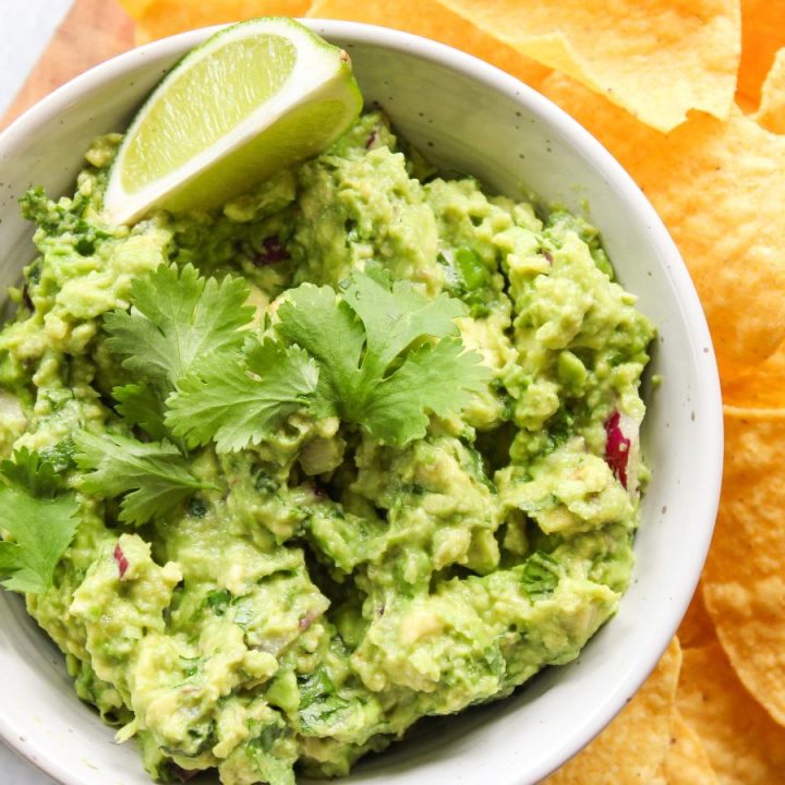 bowl of guacamole with a lime