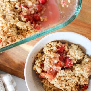 Close up of cherry crisp in a bowl and 9x13 pan