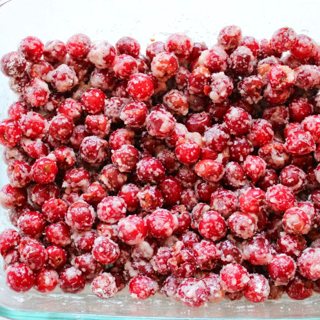 Filling mixed together for tart cherry crisp in a 9x13 pan.