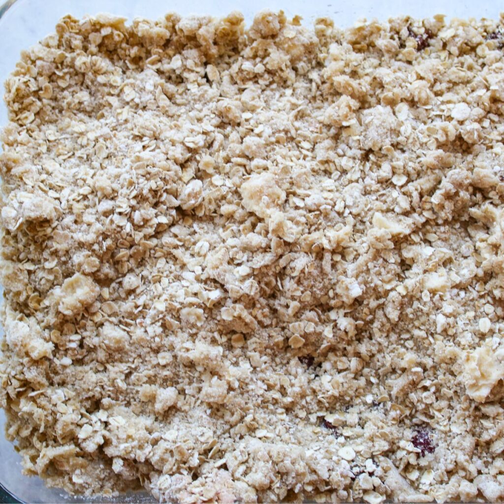 Topping added on top of cherry filling in a 9x13 pan.