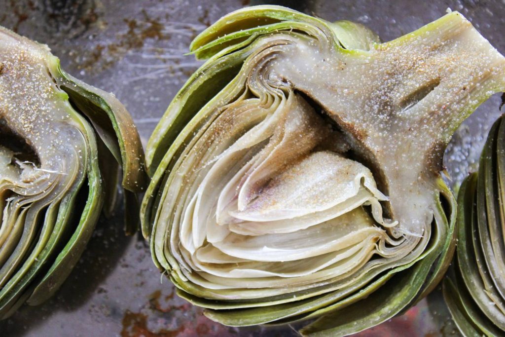 close up on boiled artichokes with seasoning