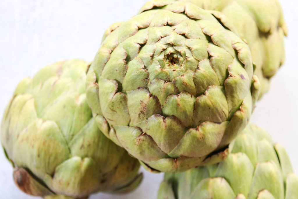 Raw and whole artichokes