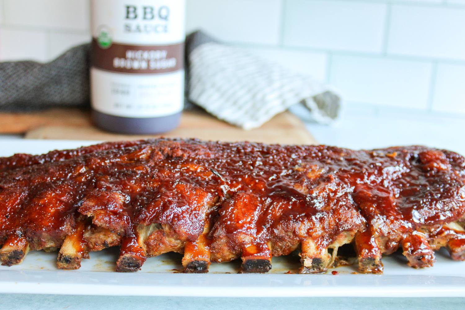 oven baked rib with bbq sauce in the background