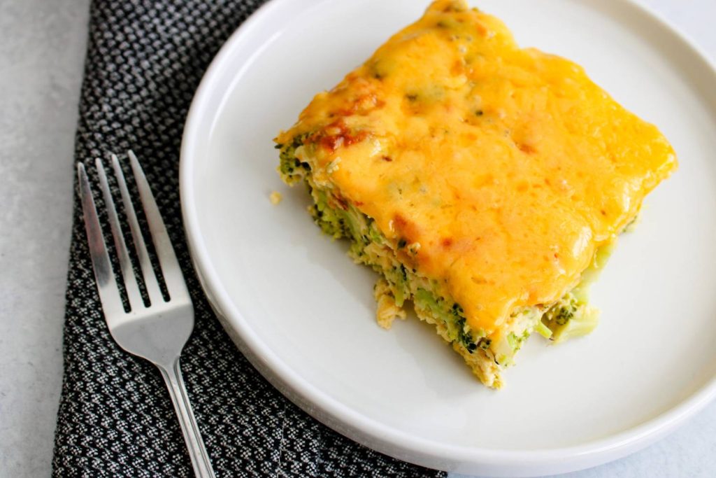 slice of the broccoli and cheddar frittata on a white plate