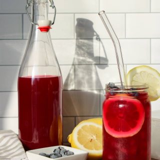 Blueberry lavender lemonade with a glass bottle filled