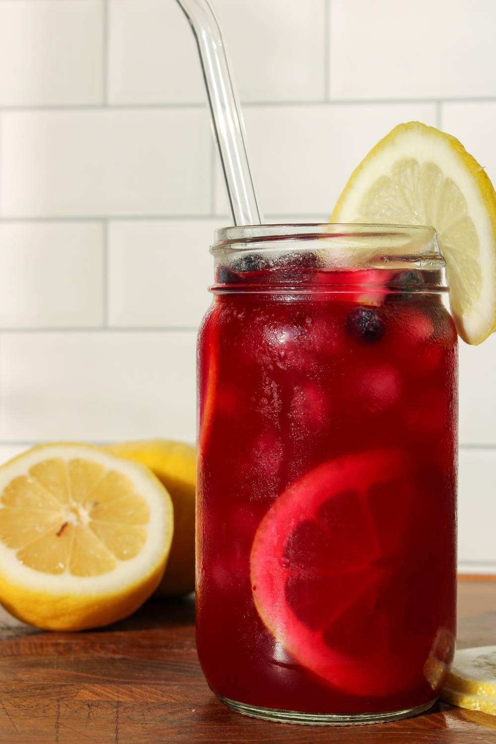 Blueberry Lavender Lemonade in a mason jar with lemons