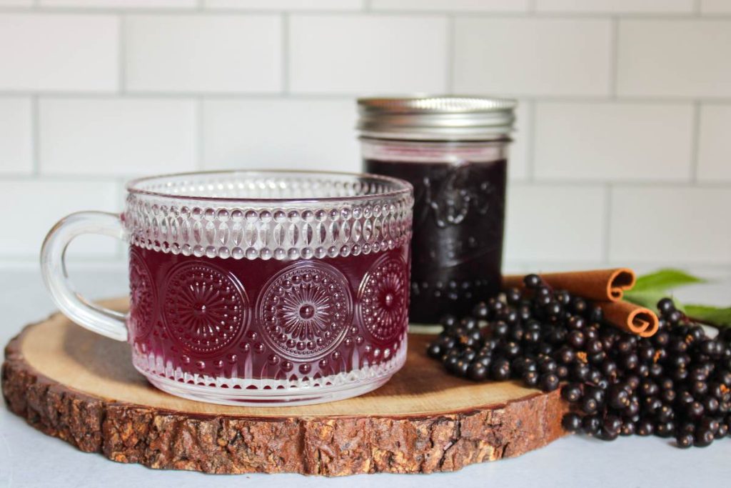 Cup of warm water with elderberry syrup