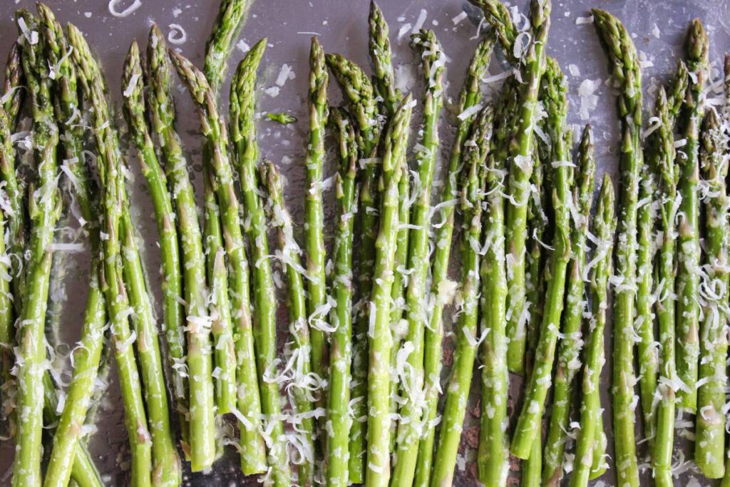 raw asparagus on a sheet pan