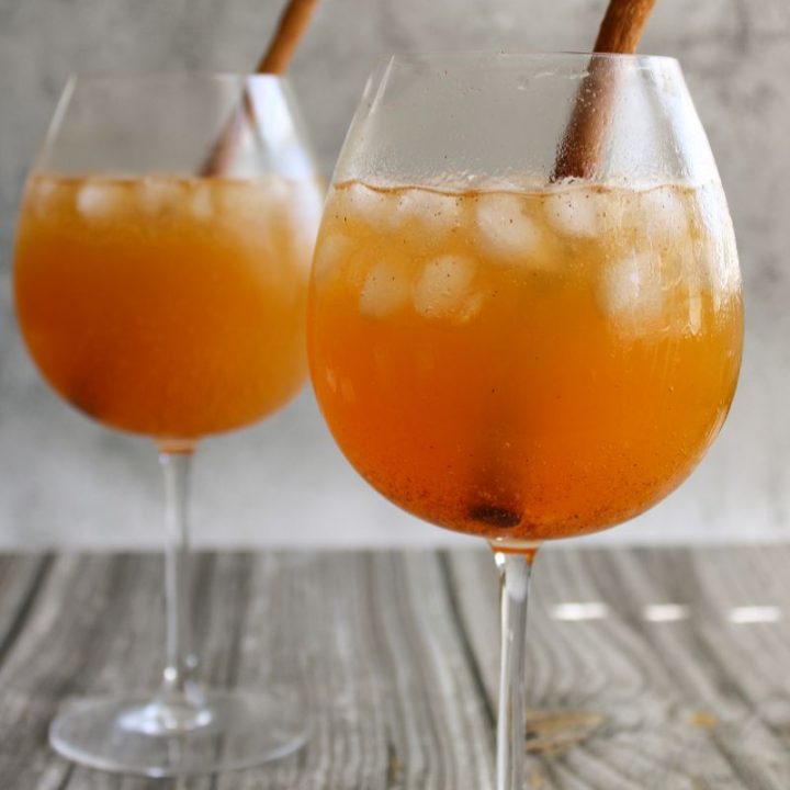 Two wine glasses filled with Pumpkin Ginger Spice Mocktail