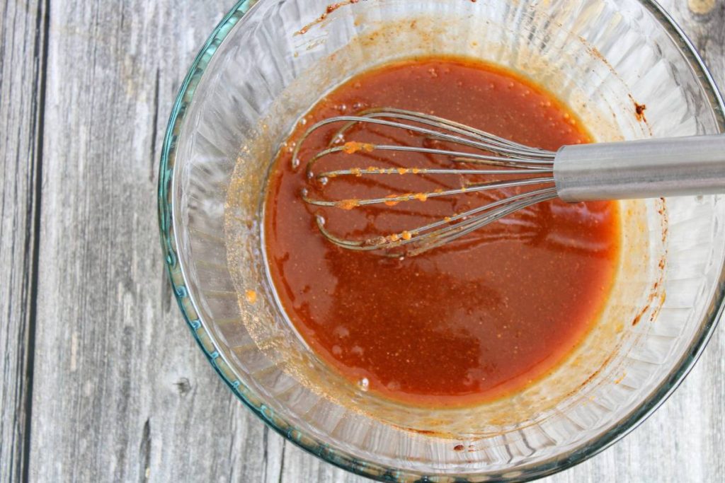 Pumpkin spice syrup in a clear bowl with a wisk