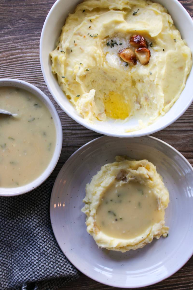 Mashed potatoes next to a bowl of gravy