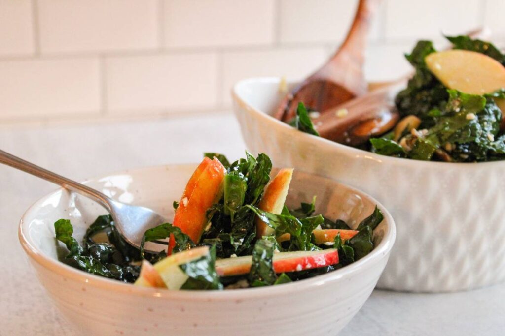 side view of fork in kale and apple salad