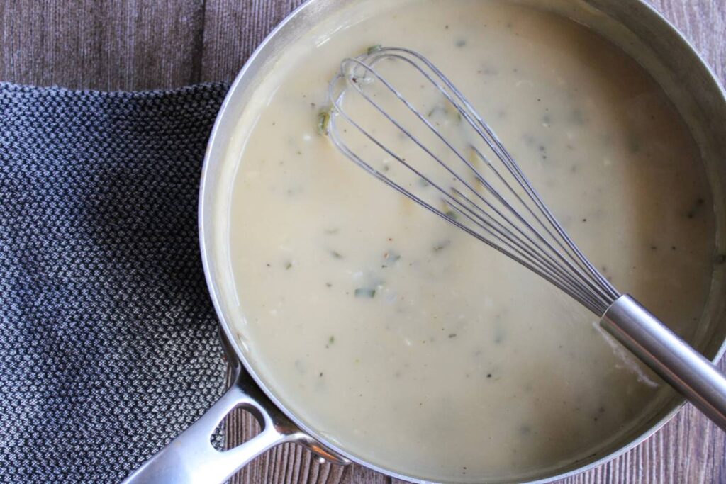 gravy in a saucepan with a whisk inside