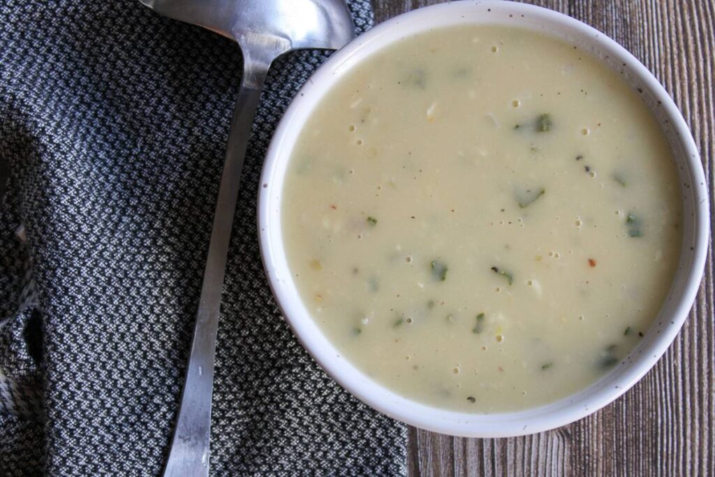 bowl of gravy next to a ladle 