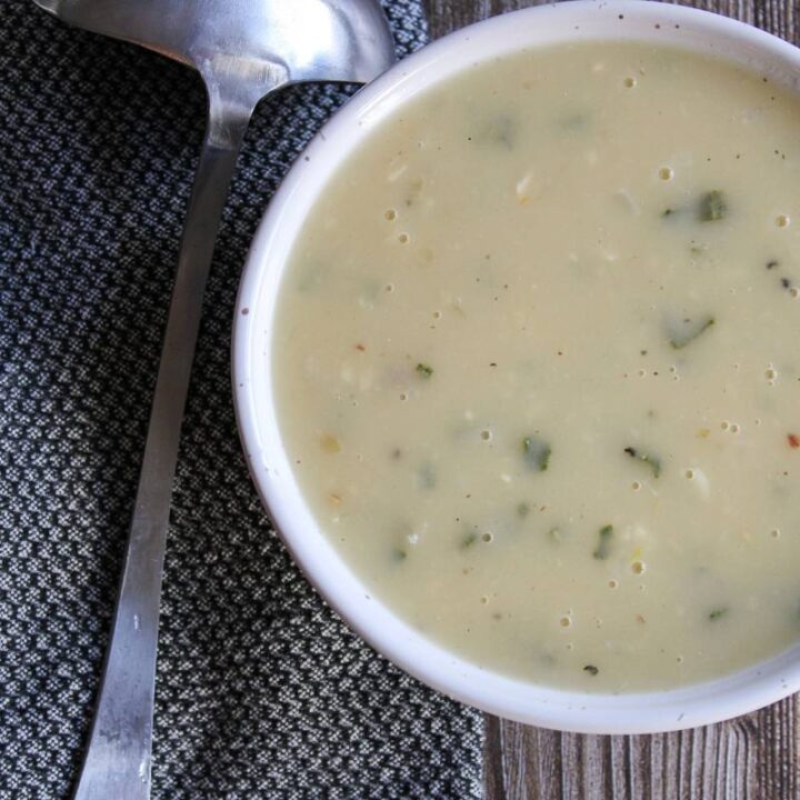 bowl of gravy next to a ladle