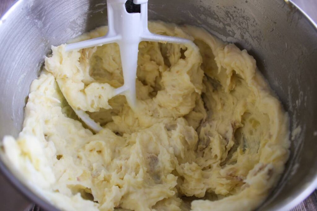 Potatoes being mashed in stand mixer