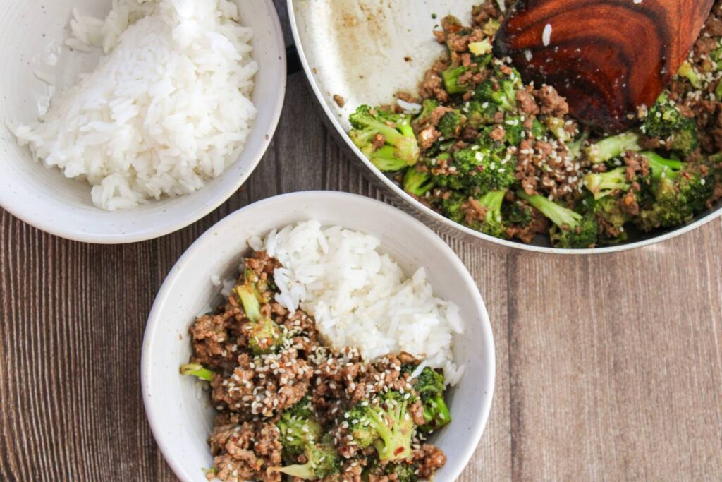 bowl of ground beef and broccoli next to rice and skillet full