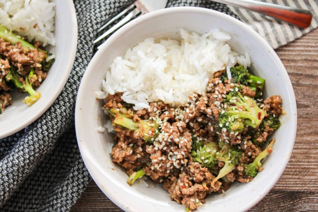 close up of a bowl of ground beef and broccoli with white rice