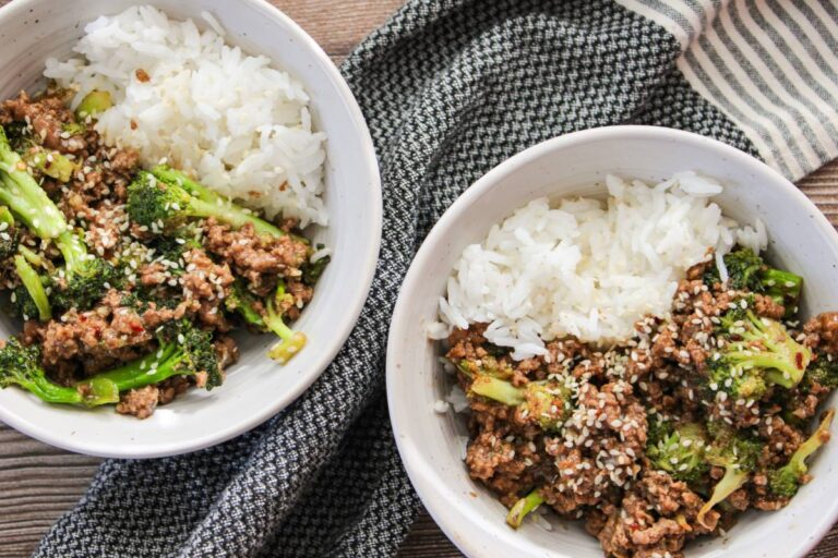 two white bowls with jasmine rice and ground beef and broccoli