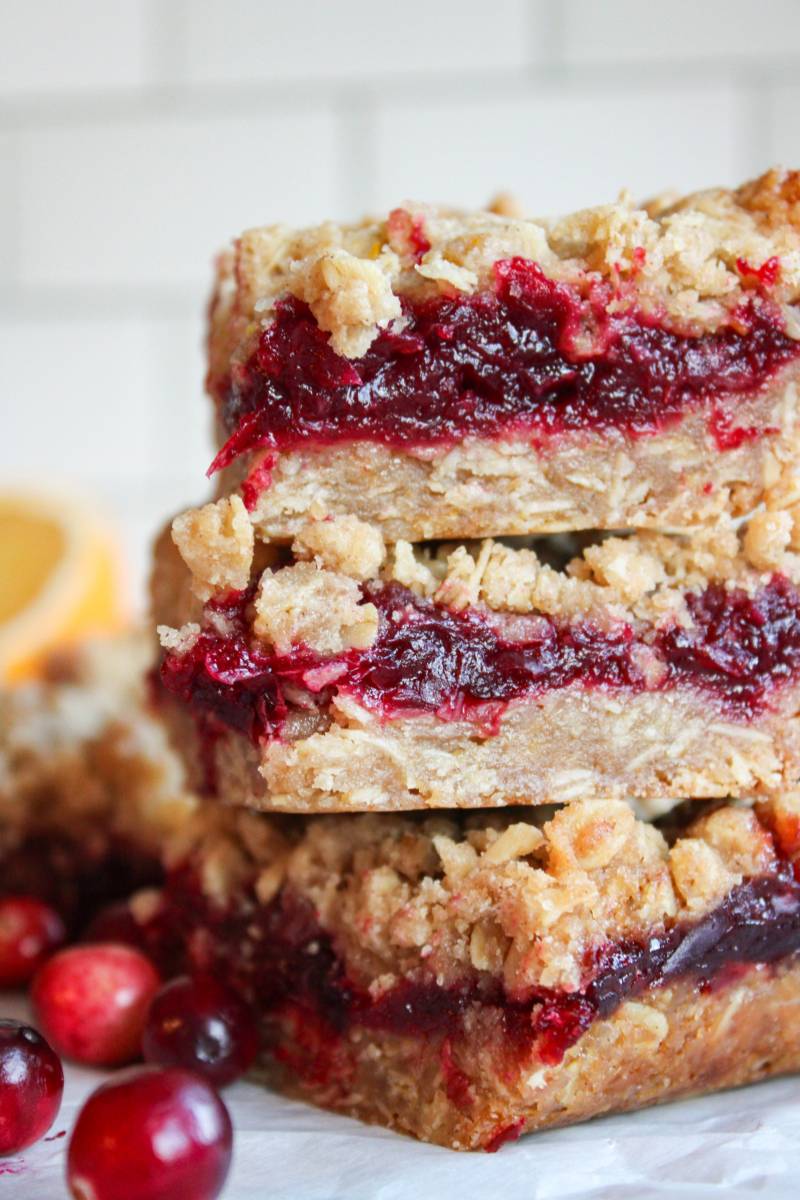 three cranberry oat bars stacked on top of each other