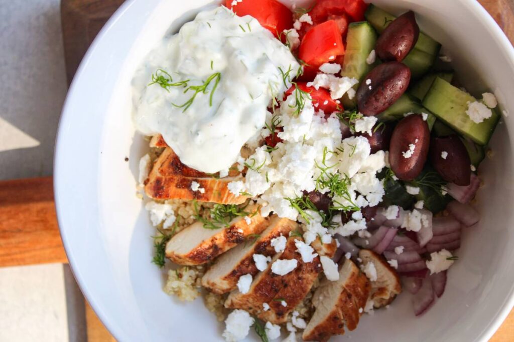 close up of Greek Chicken Quinoa Bowls with homemade tzatziki sauce