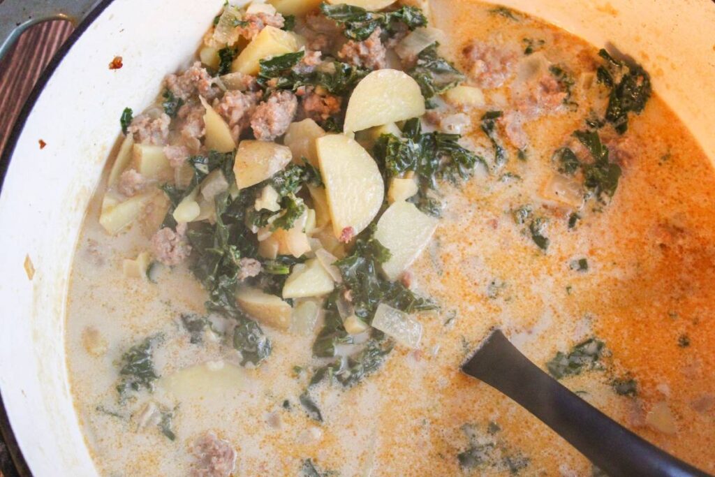 Zuppa Toscana Soup in a Dutch oven with ladle