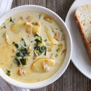 Zuppa Toscana Soup next to slices of sourdough bread