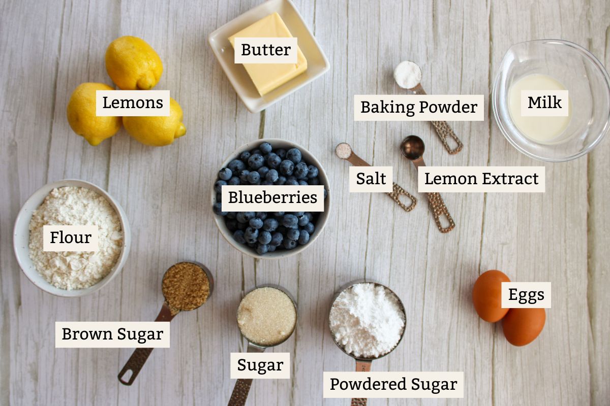 Ingredients for Blueberry Upside Down Cake on a white wooden background.