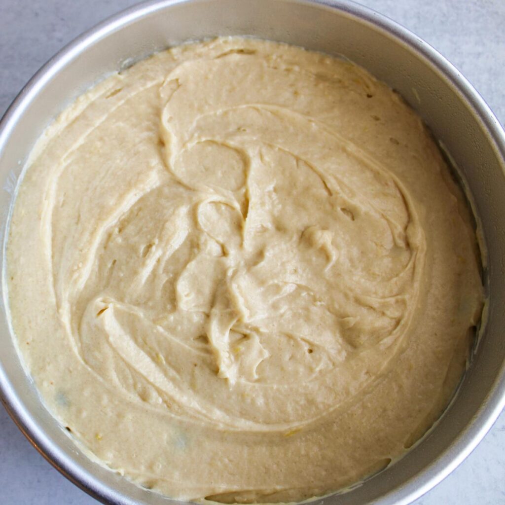 cake batter added on top of blueberry layer in a 9 inch pan.