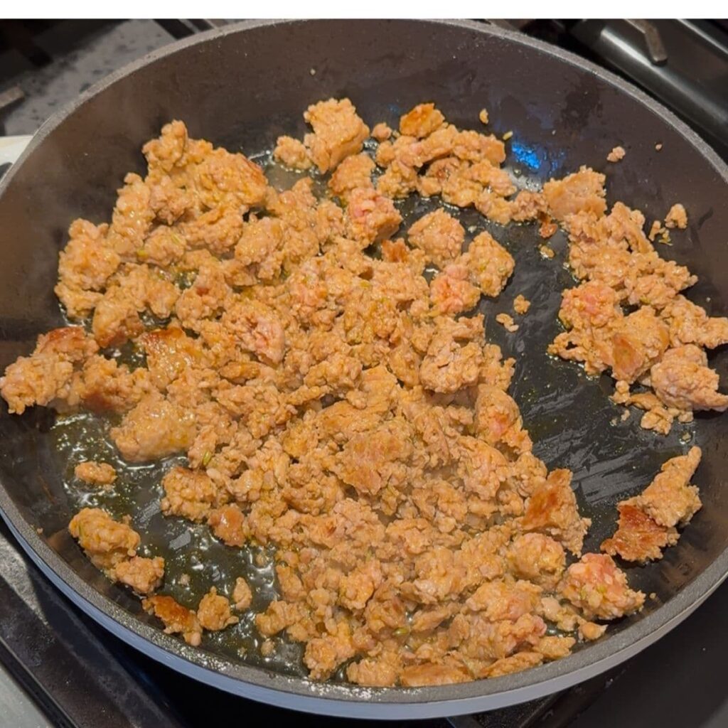 Browning Italian sausage in a skillet over medium heat.
