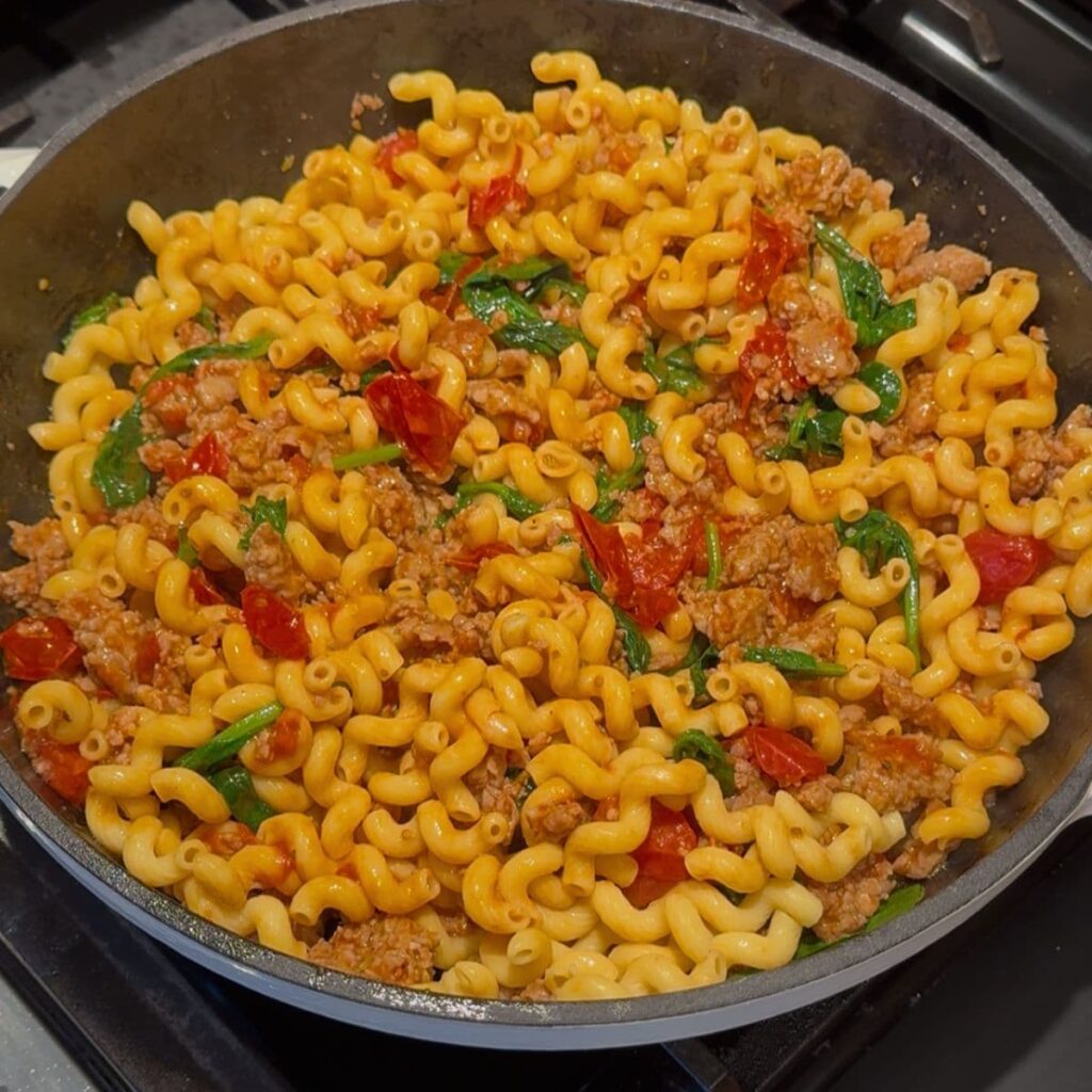 Noodles added to make high protein pasta in a skillet.