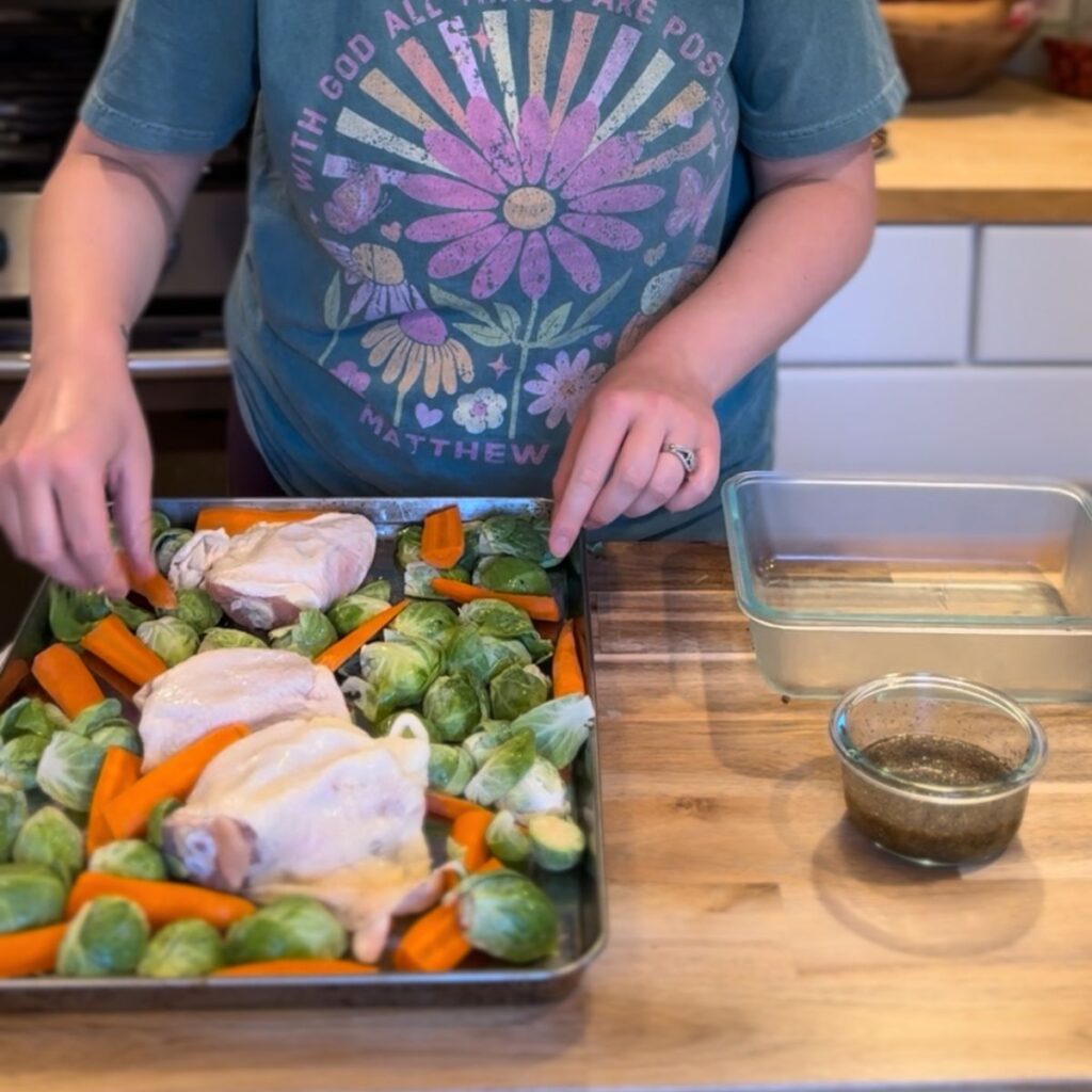 Chicken thighs, brussels sprouts and carrots on a sheet pan.
